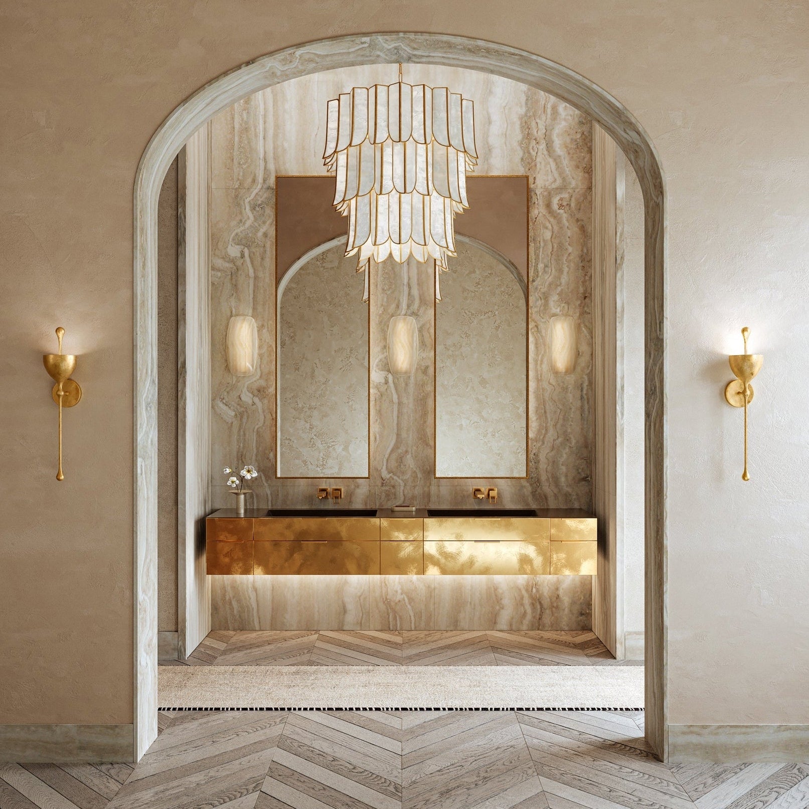 Luxurious bathroom with a large mirror, chandelier, and wall sconces.